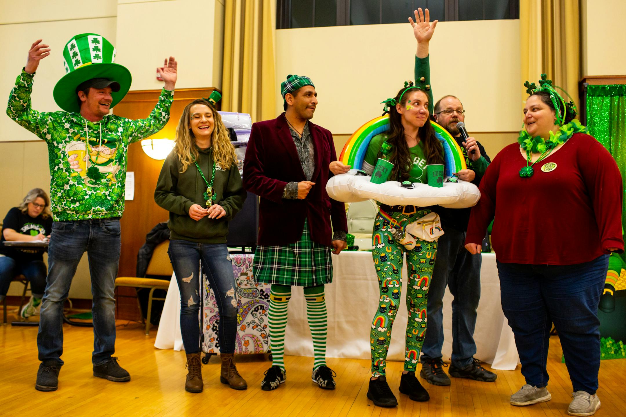 Shana Prafke, wearing a rainbow with cloud cupholders, wins the most applause during the St. Patrick's Day costume contest during Designer Purse & Gun Bingo.