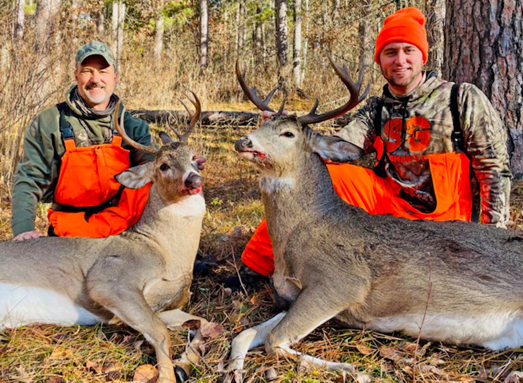 Doug Berg, left, of Chisago City, and Mitch Berg, his son, unintentionally synchronized their shots Saturday morning to harvest a pair of bucks on public land near Bemidji. Both shots were fired from a distance of about 20 yards, one second after another, from separate deer stands.