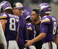 Minnesota Vikings quarterback Kirk Cousins (8) talks with head coach Kevin O'Connell after at turnover on downs in the third quarter of an NFL game be
