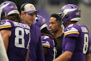 Minnesota Vikings quarterback Kirk Cousins (8) talks with head coach Kevin O'Connell after at turnover on downs in the third quarter of an NFL game be