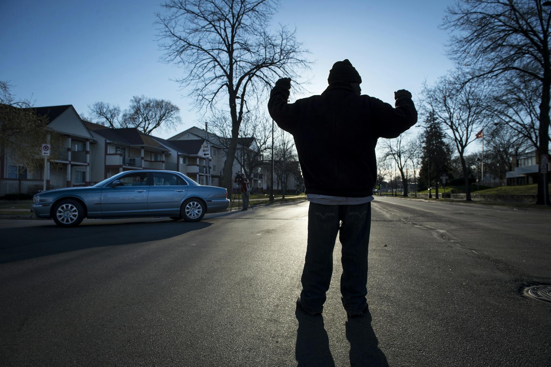 Donnie Straub, of north Minneapolis, directed traffic moving eastbound toward the Jamar Clark Memorial south down Knox Avenue before the start of Friday night's vigil.