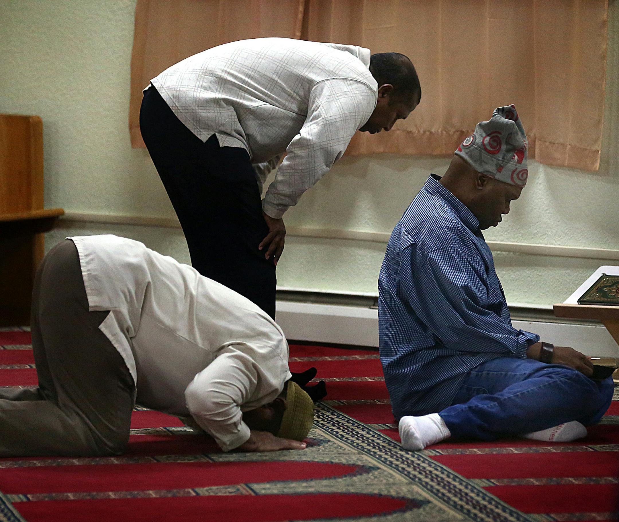 Winston Brown, New Brighton (right) and other men attended a mid-afternoon prayer and meeting at the Islamic Center of Minnesota in Columbia Heights. ] JIM GEHRZ ï james.gehrz@startribune.com / Columbia Heights, MN / October 2, 2015 / 12:00 PM ñ BACKGROUND INFORMATION: The Muslim families rallying in support of the new Quran school seemed to swallow up the opposition. Families with children, parents and grandparents filled nearly every chair, lined the walls and overflowed the Blaine C