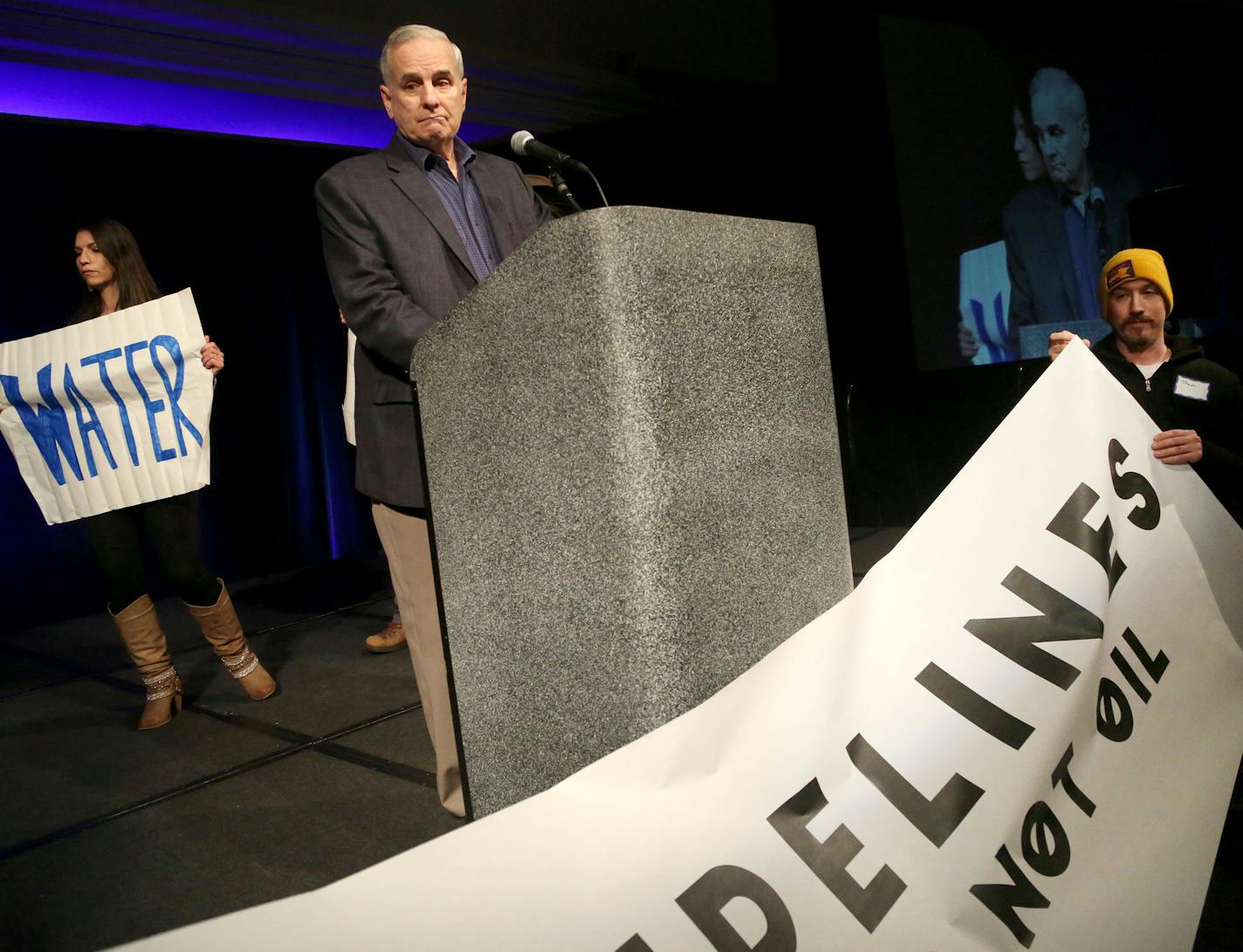 While hosting the first-ever Governor's Water Summit, Gov. Mark Dayton's speech was briefly interrupted by protesters, some of whom asked why Native American representatives were not invited to the table and also calling to block a proposed oil pipeline through Minnesota Saturday, Feb. 27, 2016, at the InterContinental Saint Paul Riverfront. Here, Gov. Dayton watched as protesters began to clear out.](DAVID JOLES/STARTRIBUNE)djoles@startribune.com Governor Mark Dayton will host the first-ever Go