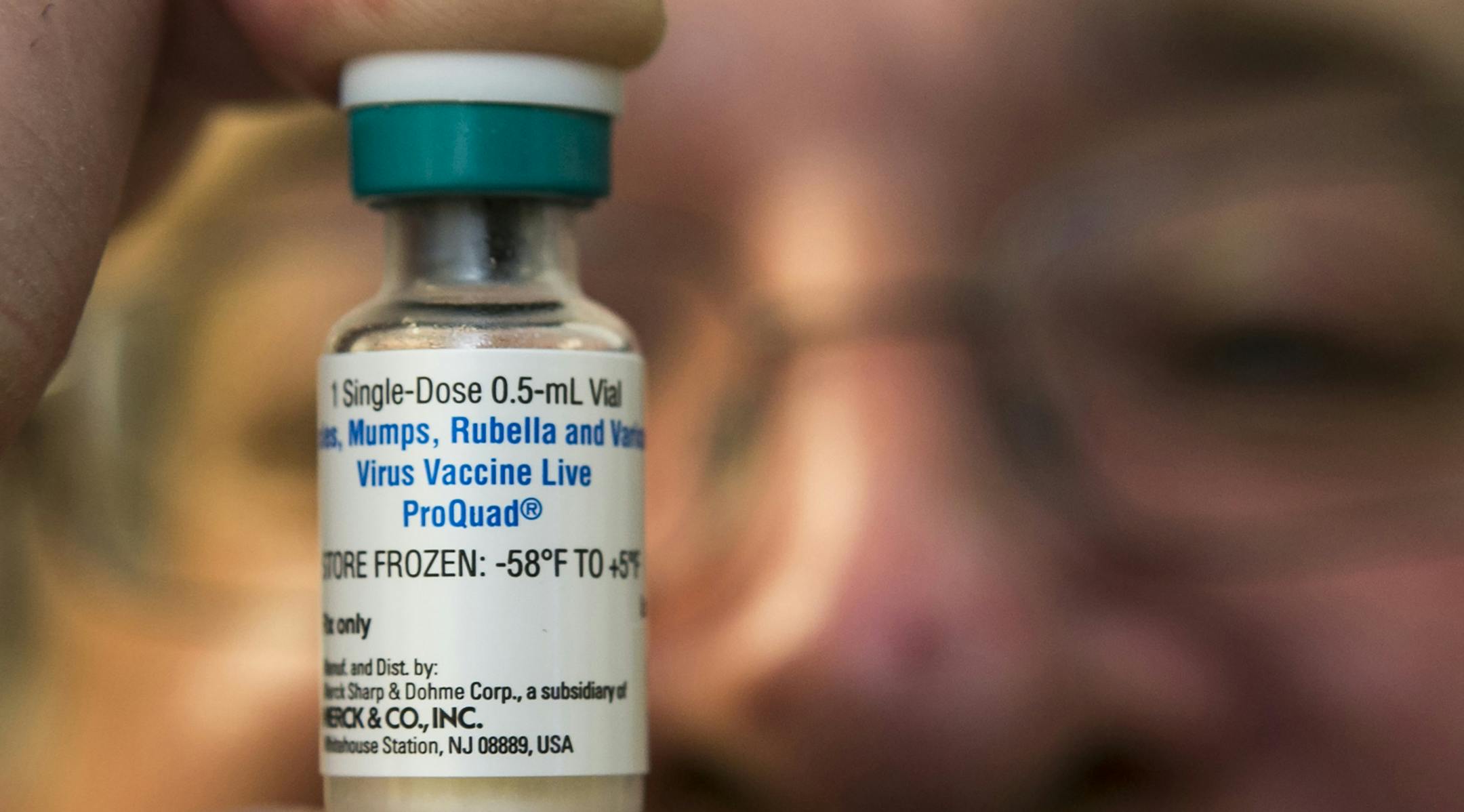 FILE - In this Thursday, Jan. 29, 2015 file photo, a pediatrician holds a dose of the measles-mumps-rubella (MMR) vaccine at his practice in Northridge, Calif. In 2014, only 21 states posted vaccination rates for individual schools, school districts, counties or areas of the state. The Centers for Disease Control and Prevention has been quietly prodding more states to make the information available. On Thursday, Aug. 27, 2015, the CDC's Dr. Anne Schuchat made the push more public during a news c