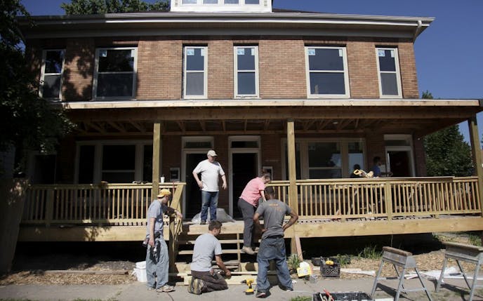 A crew from Urban Homeworks worked near 18th and Emerson. "The foreclosure crisis has hit north Minneapolis particularly hard," said Thomas Streitz, housing director for Minneapolis. Faith-based groups are "willing to take on the toughest houses and projects that other developers are not interested in."