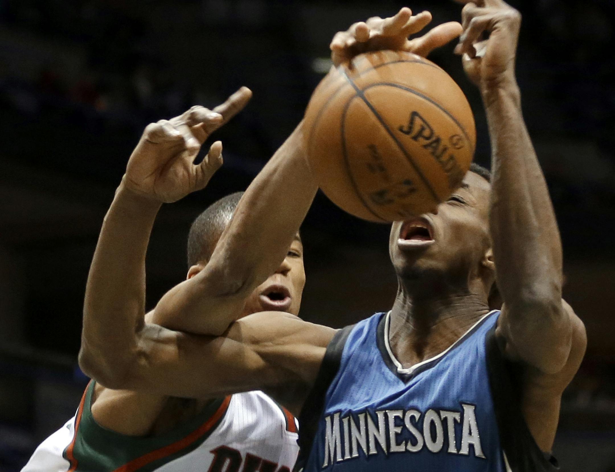 Milwaukee Bucks' Giannis Antetokounmpo fouls Minnesota Timberwolves' Andrew Wiggins during the first half of an NBA basketball game Friday, Jan. 9, 2015, in Milwaukee. (AP Photo/Aaron Gash)