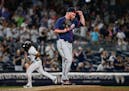 Twins relief pitcher Buddy Boshers adjusted his cap as the Yankees' Aaron Hicks ran the bases after hitting a home run during the eighth inning Friday