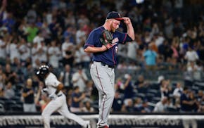 Twins relief pitcher Buddy Boshers adjusted his cap as the Yankees' Aaron Hicks ran the bases after hitting a home run during the eighth inning Friday