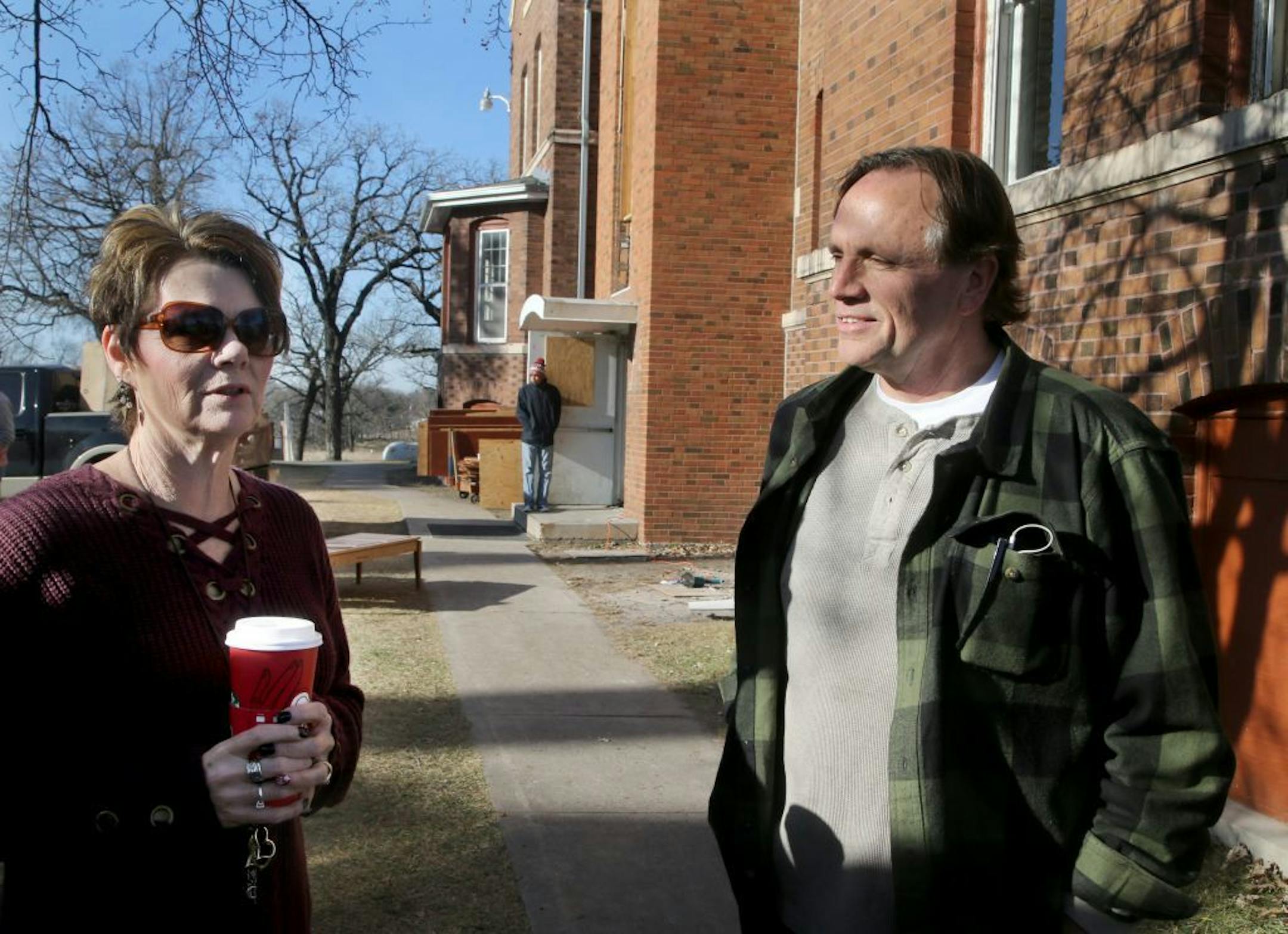 Volunteers will be painting, ripping tiles, cleaning and working on two century-old cottages as part of an effort to preserve them and turn them into veterans housing, spearheaded by nonprofit Eagle's Healing Nest. Here, Melony Butler, who runs the Eagle's Healing Nest, left, and Sen. Jim Abeler, R-Anoka, talk outside cottage 2, which already houses formerly homeless vets Saturday, Dec. 2, 2017, in Anoka, MN.