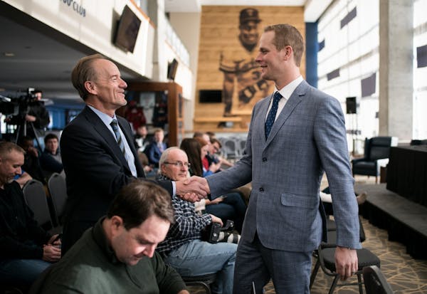 Twins owner Jim Pohlad shook hands with former first baseman Justin Morneau before Morneau's news conference officially announcing his retirement Wedn