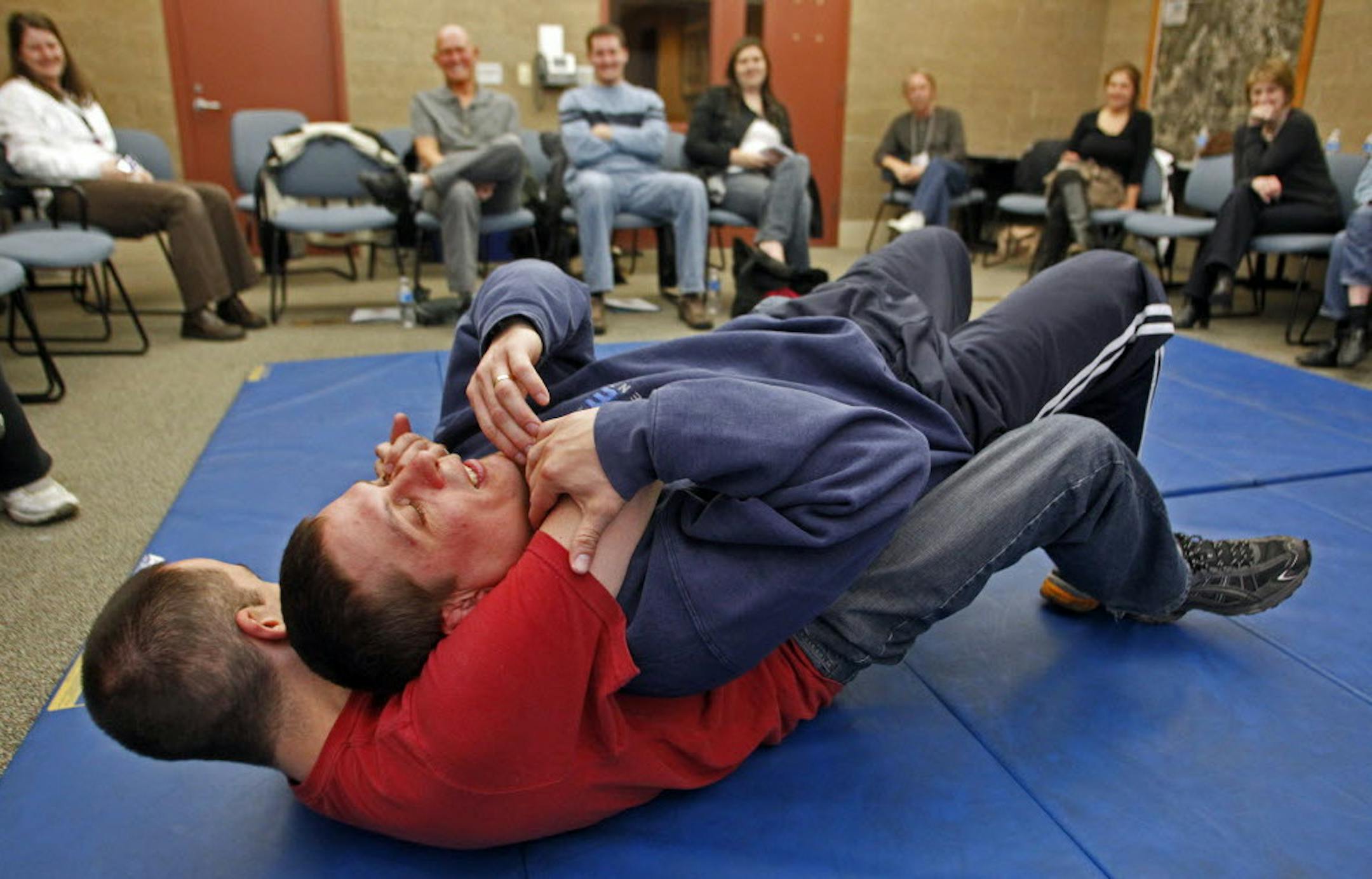 FLE PHOTO BY MARLIN LEVISON*mlevison@startribune. Twenty-five Eagan residents are participating in an eight week program designed to better understand the workings of the Eagan police department. A recent session dealt with fire arms training and self defense methods. THIS PHOTO: ] Eagan police officers Tony Lejcher, bottom and Tony Sundgaard demonstrated self defense techniques to the academy attendees.