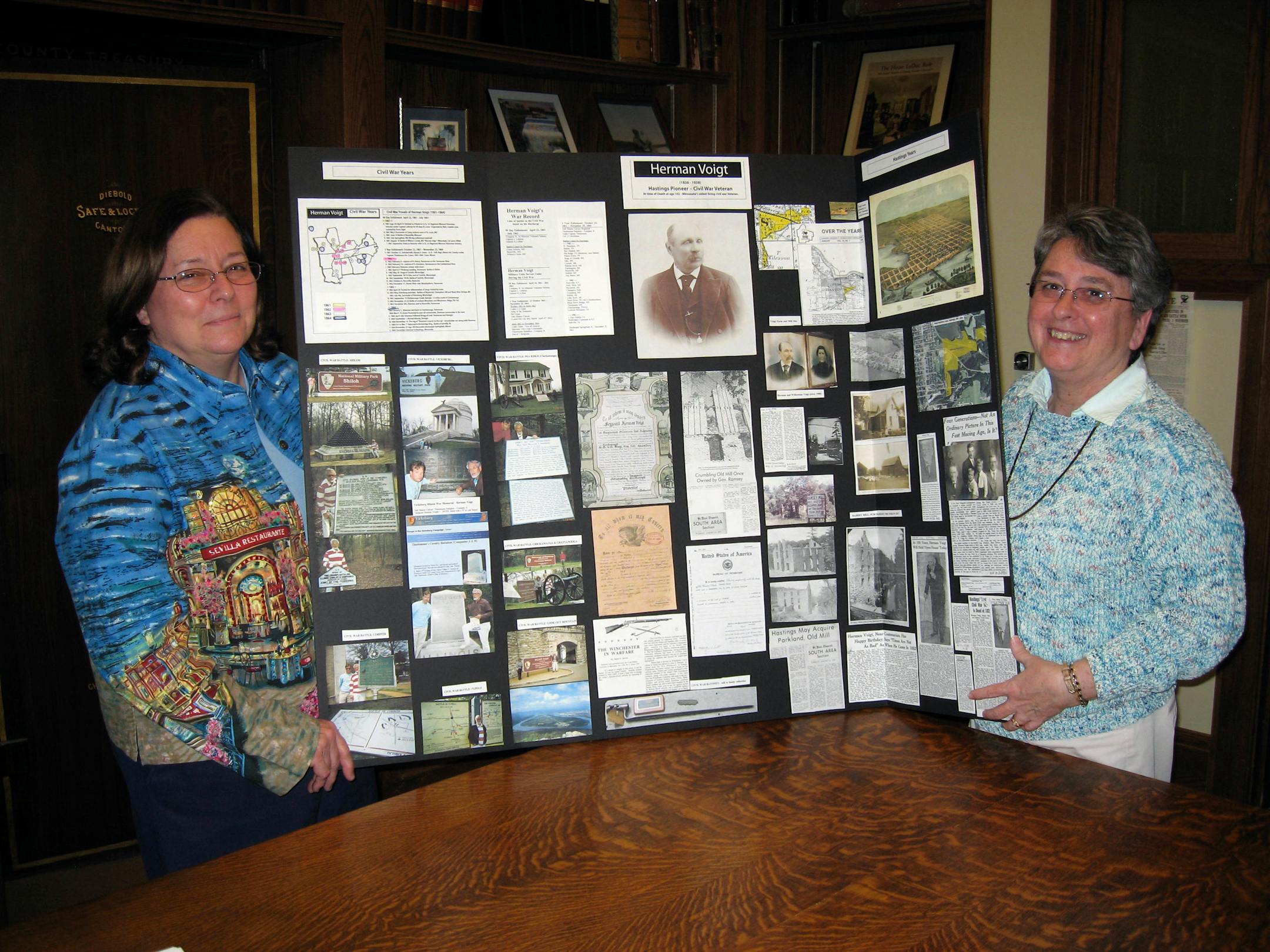 Cindy Thury Smith, left, curator of the Pioneer Room at Hastings City Hall, stood before a historical display with Shirley Dalaska, who is spending 5 years researching Civil War soldiers from Dakota County.
