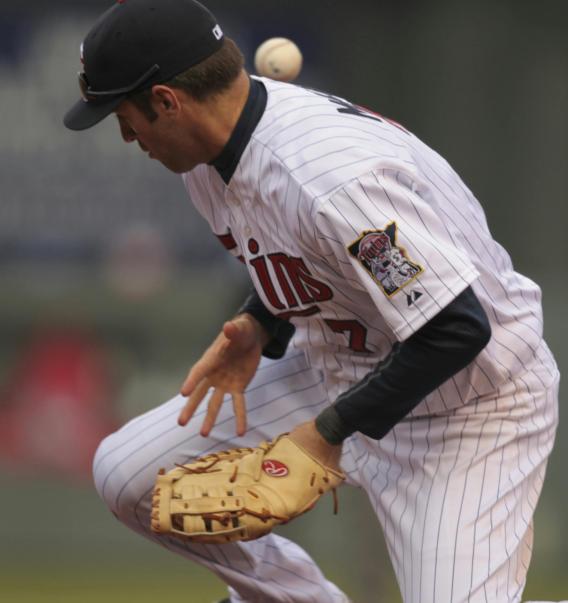 The Twins' lost their Home Opener 5-1 Monday afternoon, April 9. 2012 to the Los Angeles Angels at Target Field in Minneapolis, Minn. The Angels' Kendrys Morales reached first base in the sixth inning on first baseman Joe Mauer's error fielding the grounder. Moments later, Morales reached second after second baseman Alexi Casilla, backing up Mauer, commited a throwing error. ] JEFF WHEELER ‚Ä¢ jeff.wheeler@startribune.com ORG XMIT: MIN2014021501393323