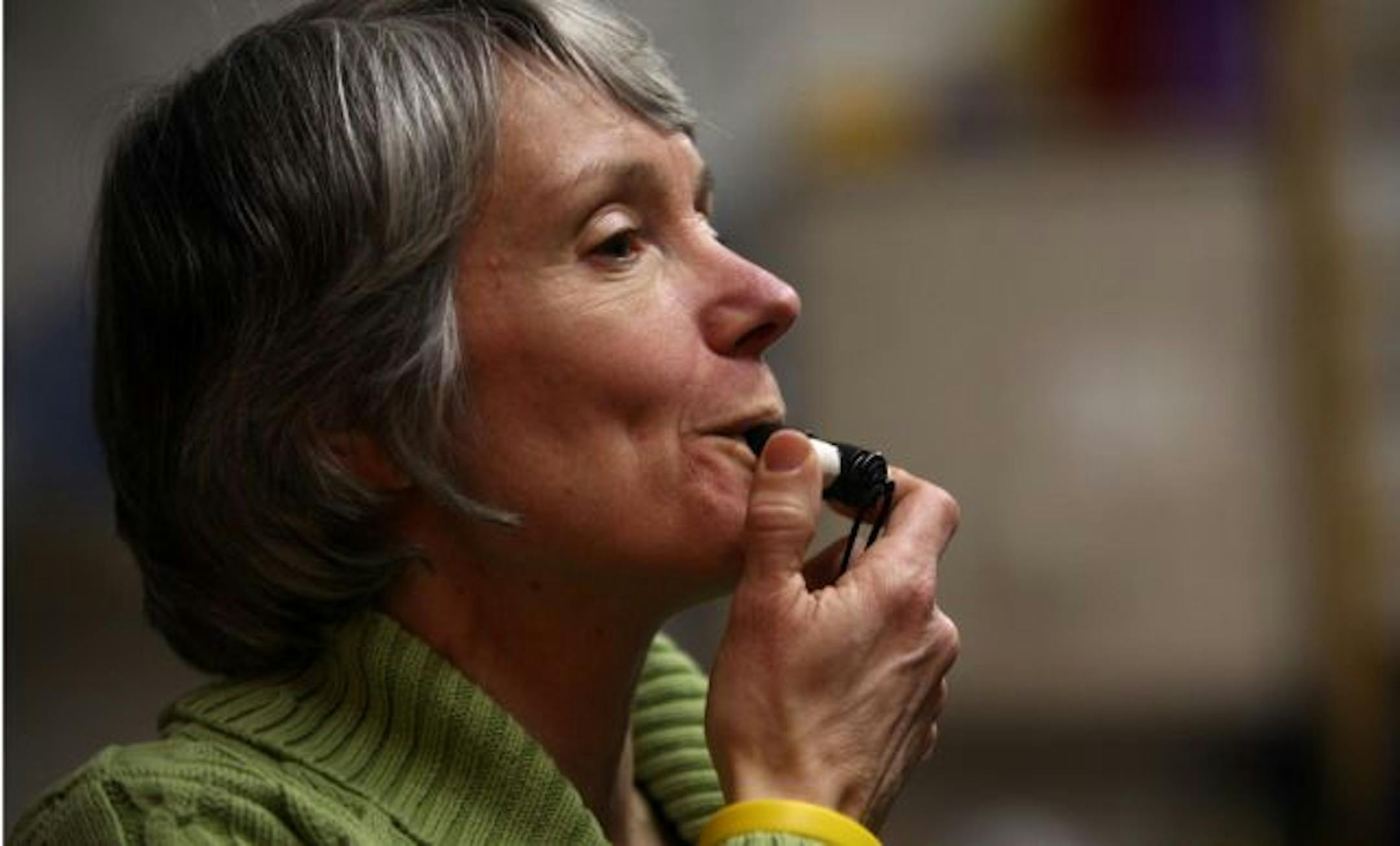 Marisa Cuneo-Linsly, of the Women's Drum Center, blew her whistle to the beat as she lead the group.