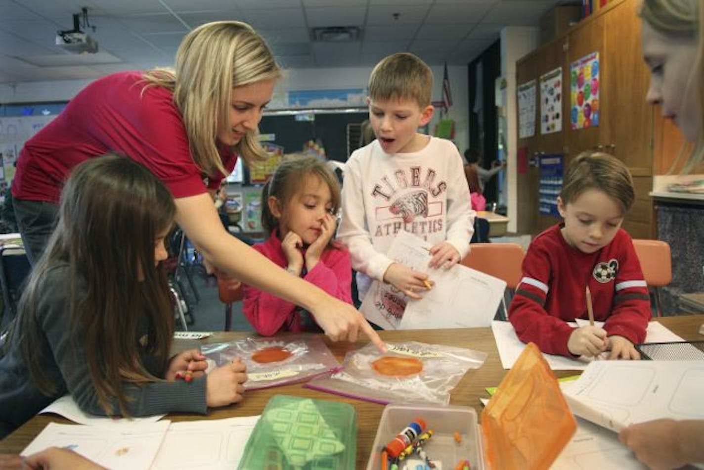 Forest View Elementary first-grade teacher Brittany Cullen, showed her students what germs look like in bags labeled "Mano" for hand and "fuente de beber" for water fountain.