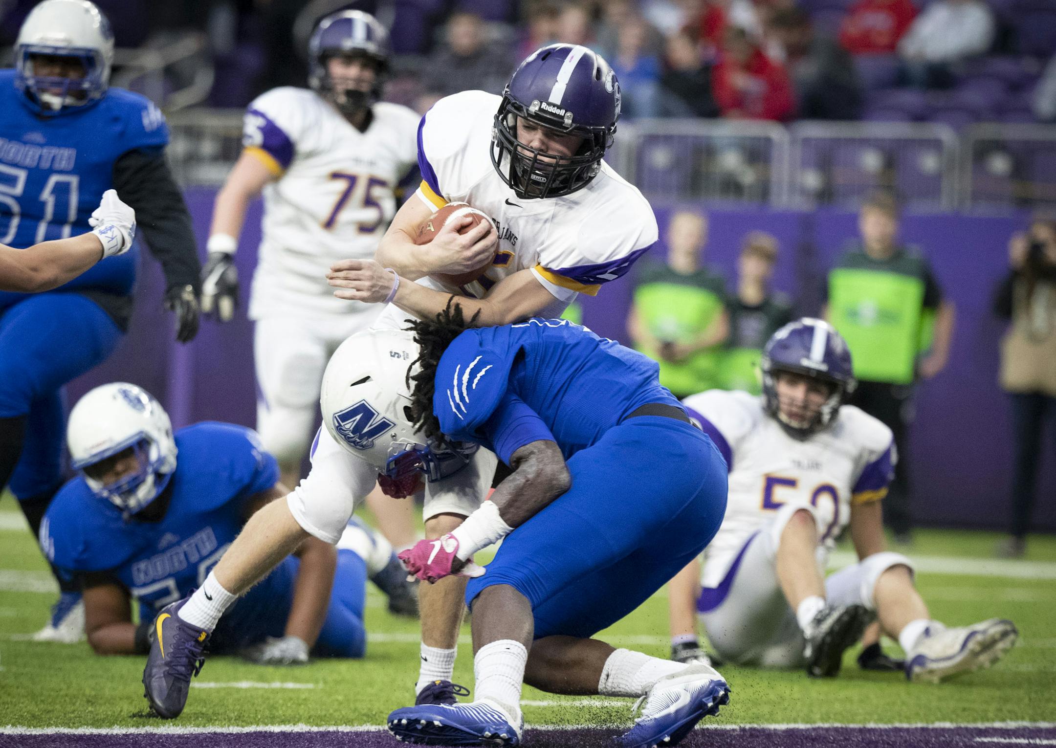 Barnesville's Adam Tonsfeldt (5) scored the extra two points as Minneapolis North's Taqurius Wair (5) tried to push back in the first quarter. ] RENEE JONES SCHNEIDER • renee.jones@startribune.com The State Football Tournament Class AA semi-finals between Minneapolis North and Barnesville at U.S Bank Stadium in Minneapolis, Minn., on Friday, November 16, 2018.