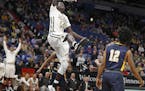 Goanar Mar of DeLaSalle dunked over the Columbia Heights defenders during semifinal class 3A basketball action at Target Center Thursday March 23, 201
