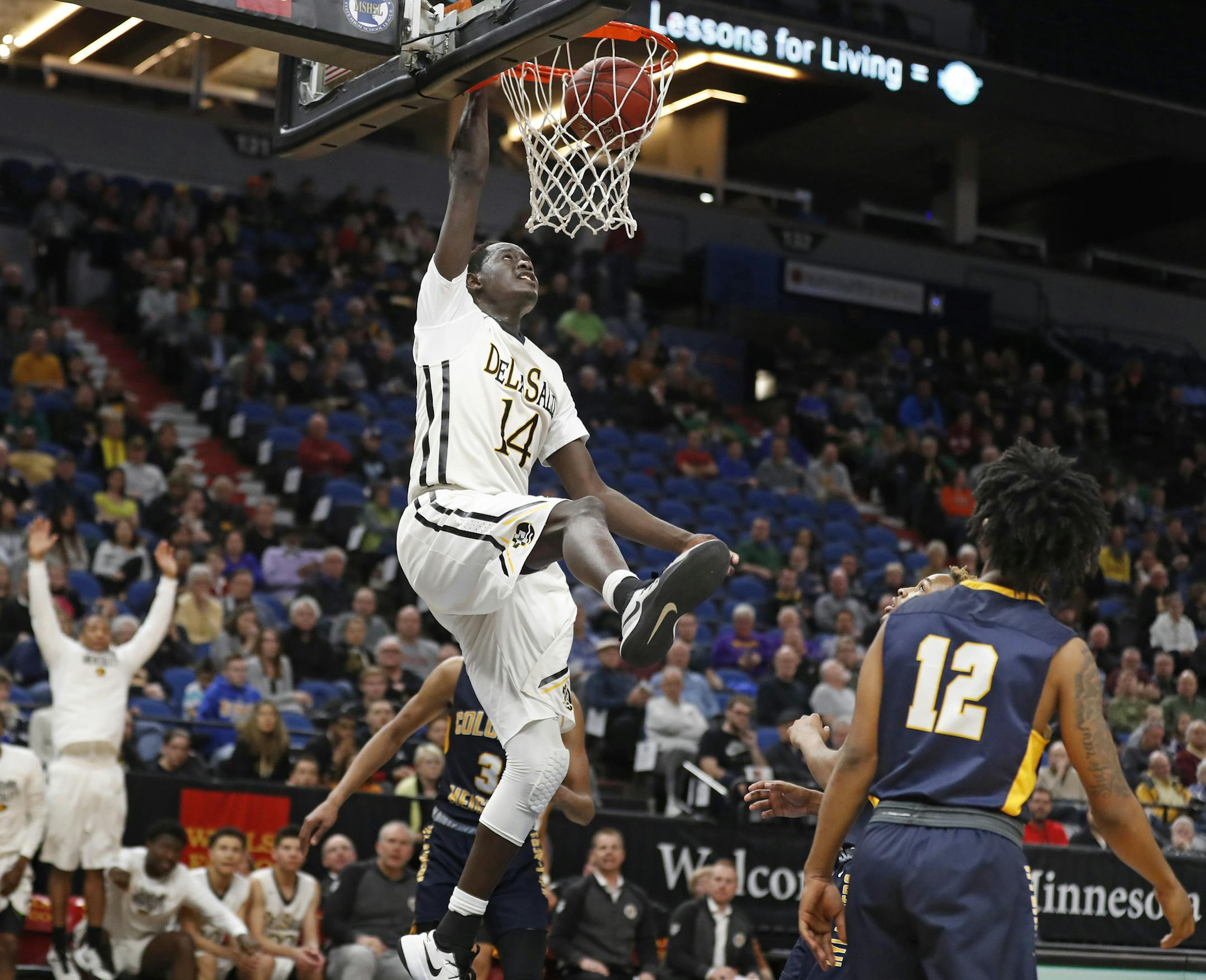 Goanar Mar of DeLaSalle dunked over the Columbia Heights defenders during semifinal class 3A basketball action at Target Center Thursday March 23, 2017 in Minneapolis, MN.] DeLaSalle Islanders beat Columbia Heights Hylanders 86-60. JERRY HOLT &#xef; jerry.holt@startribune.