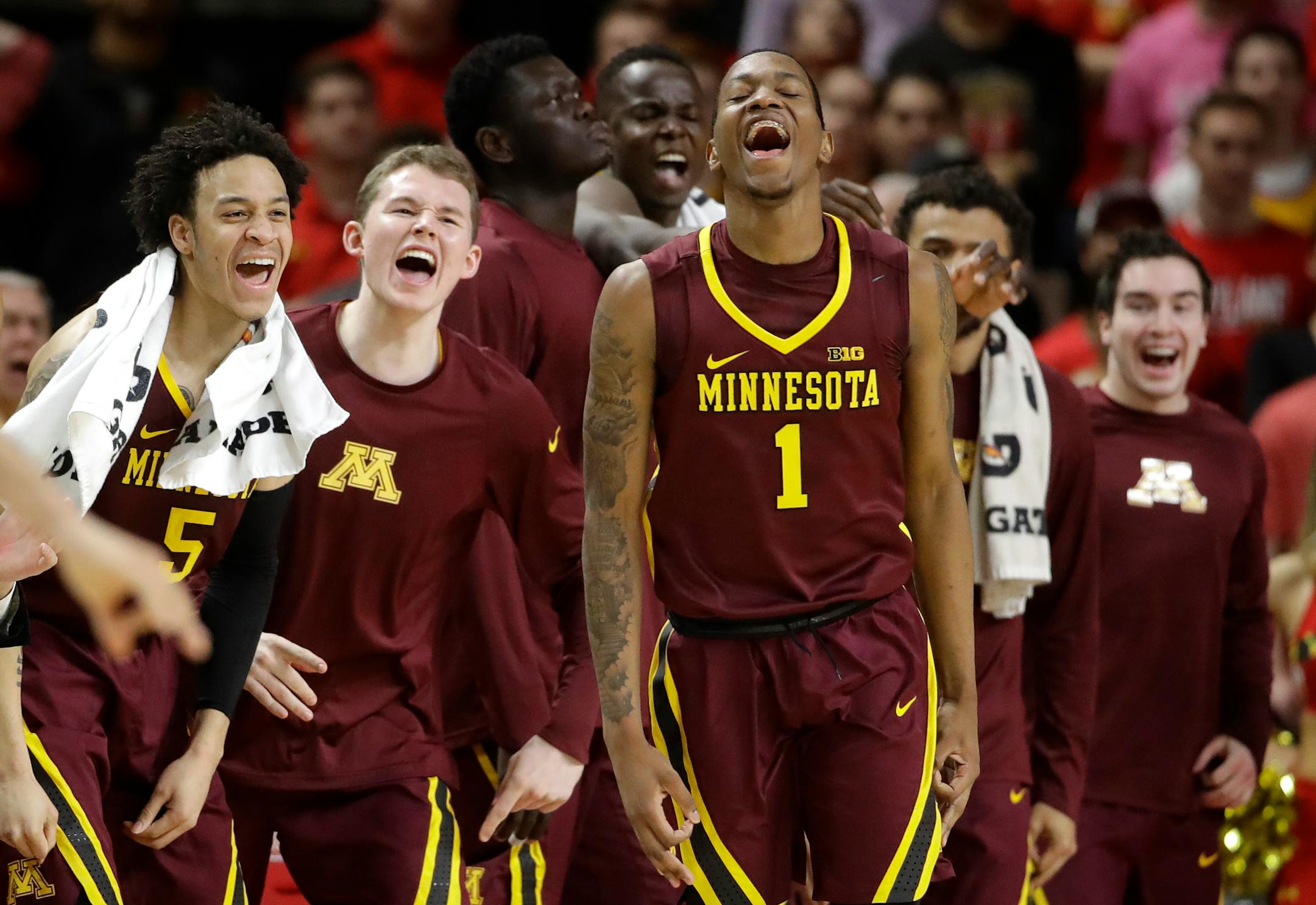 Minnesota guard Dupree McBrayer (1) reacts in front of teammates after making a 3-pointer during the second half of the team's NCAA college basketball game against Maryland, Wednesday, Feb. 22, 2017, in College Park, Md. Minnesota won 89-75. (AP Photo/Patrick Semansky)