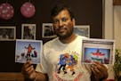 FILE- In this July 4, 2016 file photo, Indian climber, Satyarup Sidhantha holds on his right hand a photograph that shows him on Mount Everest, along 