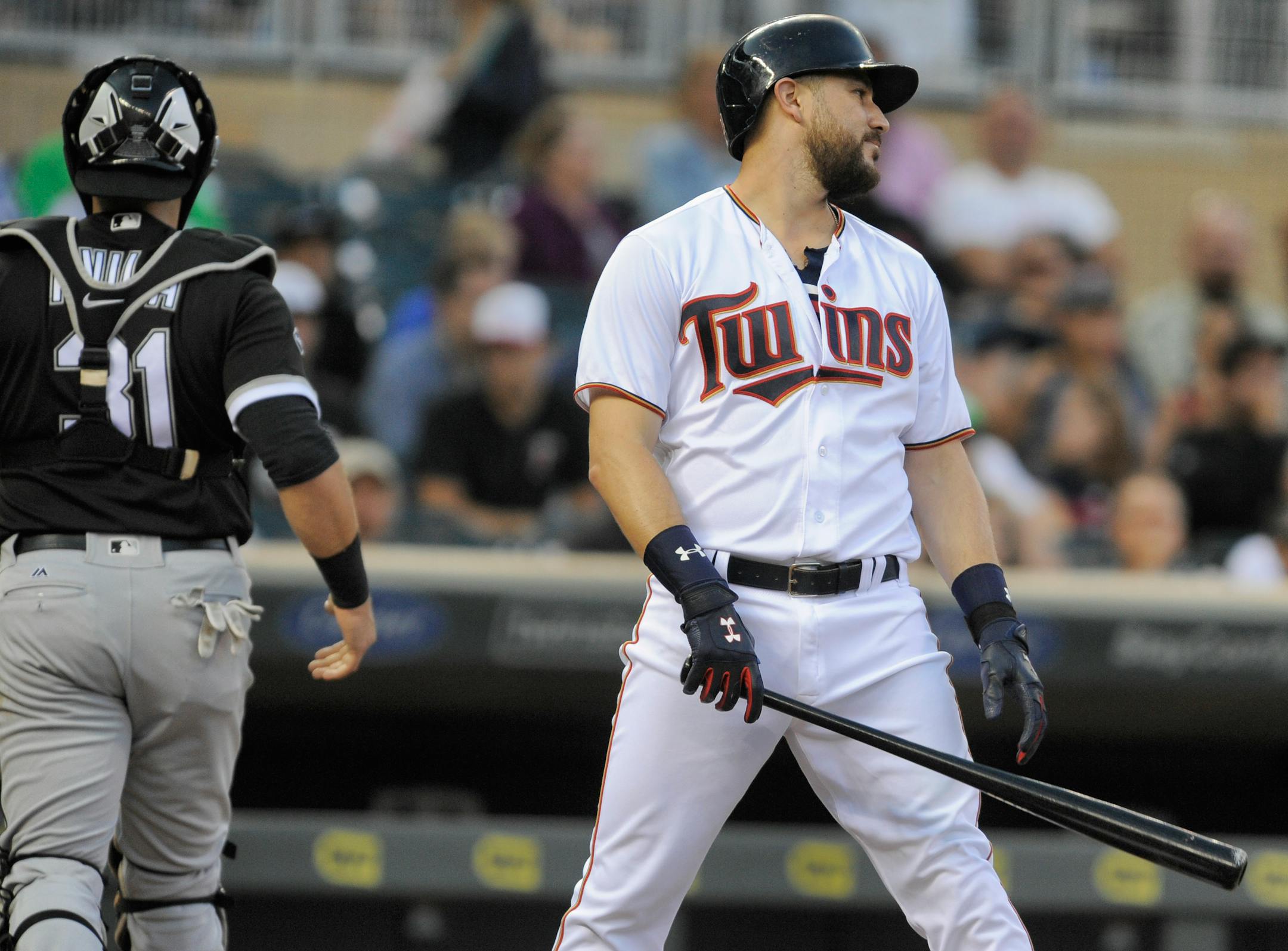 Minnesota Twins' Trevor Plouffe, right, reacts after striking out as Chicago White Sox catcher Alex Avila, left, heads to the dugout during the first inning of a baseball game, Thursday, Sept.. 1, 2016, in Minneapolis. (AP Photo/Tom Olmscheid)