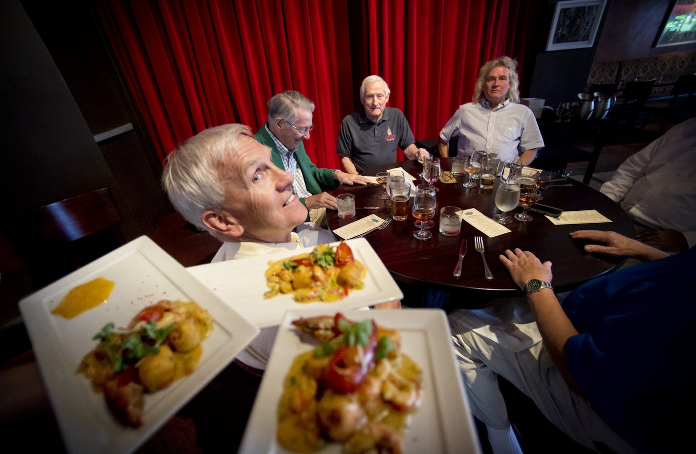 The second course of crawfish etouffee is delivered to the diners. The Minnesota Epicurean Society met Wednesday August 7, 2013, at Cafe Maude at Loring for a five-course meal with paired cocktails. For 42 years, a local Epicurean Club has been gathering for a late -- and long -- lunches once a month at restaurants. Never the same one twice. ] GLEN STUBBE * gstubbe@startribune.com