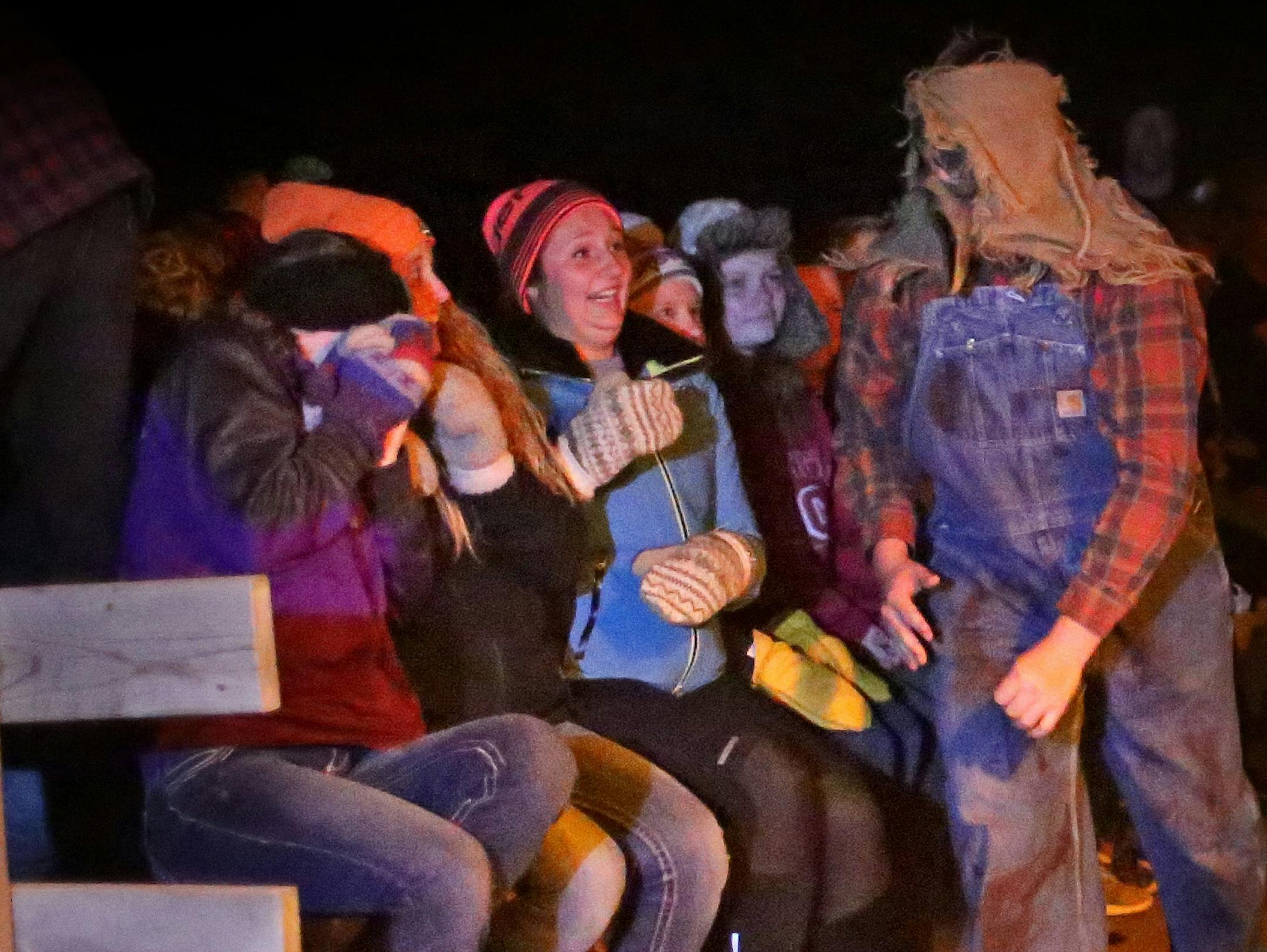 One of the characters at "Molitors Haunted Acres" surprises guests on the "Wagon of Doom" as it trundles past the shantytown.