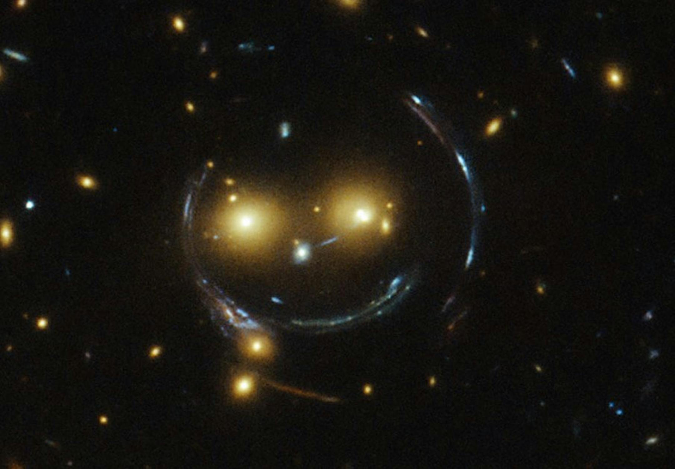 NASA's Hubble telescope spotted what appears to be a smiling face in a galaxy cluster.