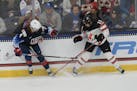 Caroline Harvey of Team USA and Canada’s Brianne Jenner (19) battled for the puck during a game Friday in Maryland Heights, Mo.