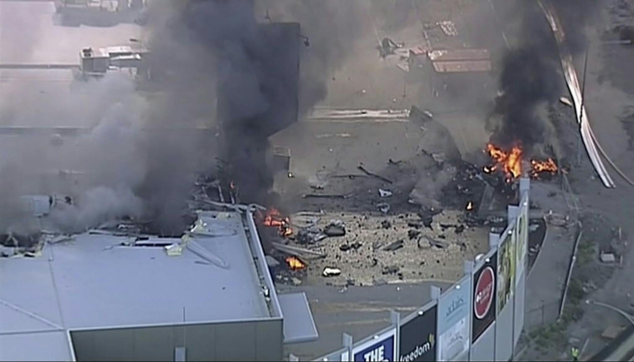 This image made from video shows the site of a plane crash at Essendon Airport in Melbourne, Australia Tuesday, Feb. 21, 2017. An official says a light plane has crashed into a shopping mall in the city of Melbourne.