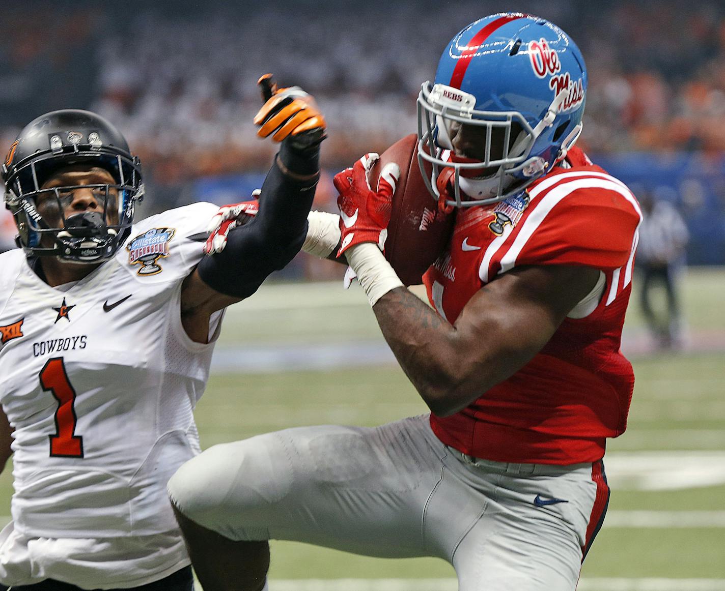 FILE - In this Jan. 1, 2016, file photo, Mississippi wide receiver Laquon Treadwell, right, pulls in a touchdown reception in front of Oklahoma State cornerback Kevin Peterson (1) during the first half of the Sugar Bowl NCAA college football game in New Orleans. Treadwell is one of the top offensive players available in the NFL Draft, which starts April 28 in Chicago.(AP Photo/Bill Feig, File)