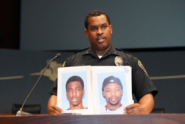 At a news conference Monday, Bloomington Police Chief Booker Hodges held photos of Shamar Alon Ramon Lark, left, and Rashad Jamal May, sought in conne