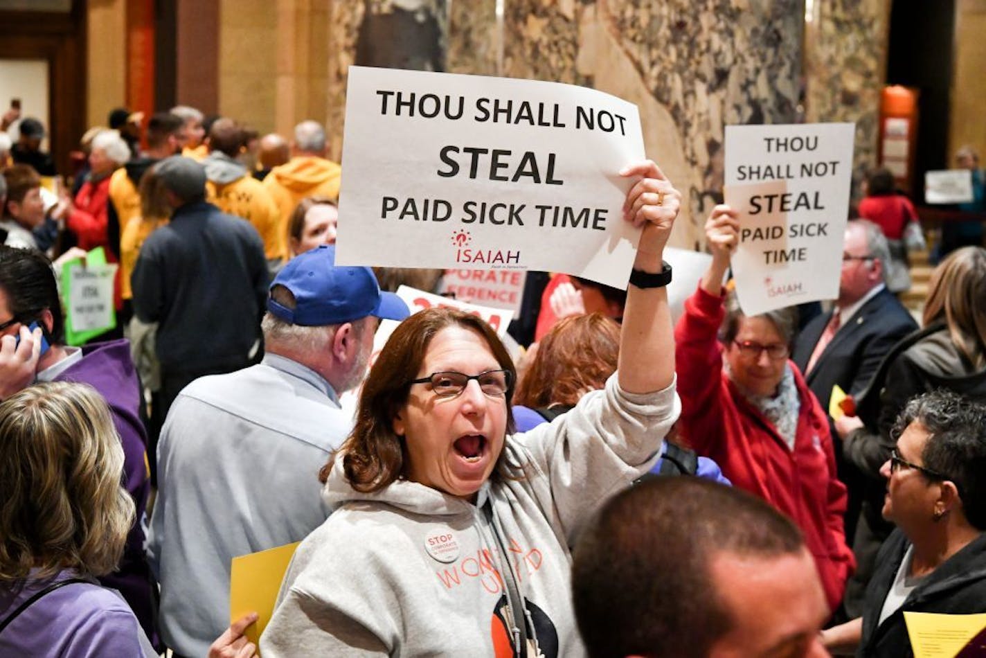 A coalition of groups including Main Street Alliance, TakeAction Minnesota, Neighborhoods Organizing for Change (NOC), SEIU Minnesota, AFL-CIO, and ISAIAH protested the preemption bill outside the Senate Chamber Thursday morning.