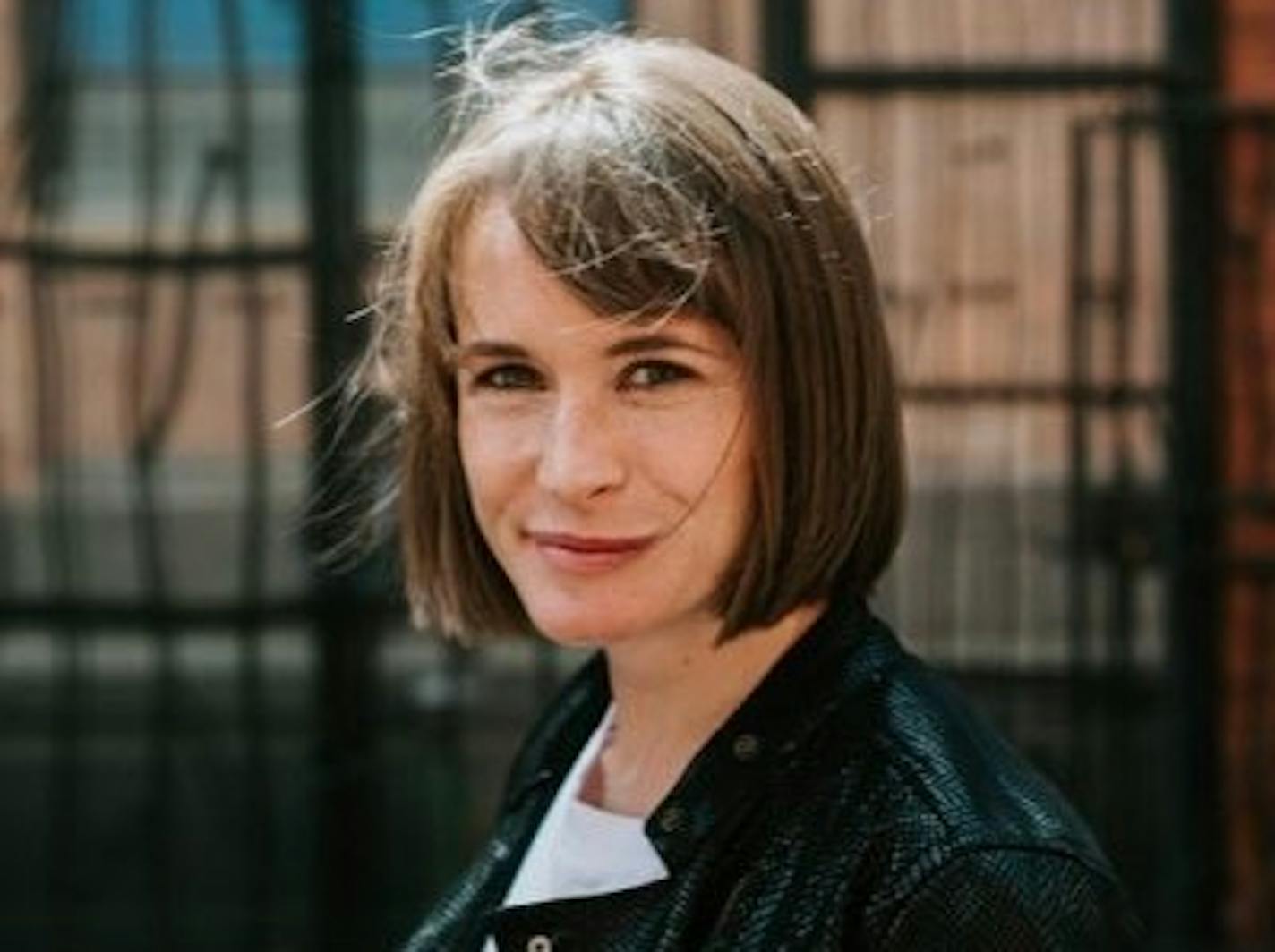 photo of author Abigail Dean in front of  an iron fence