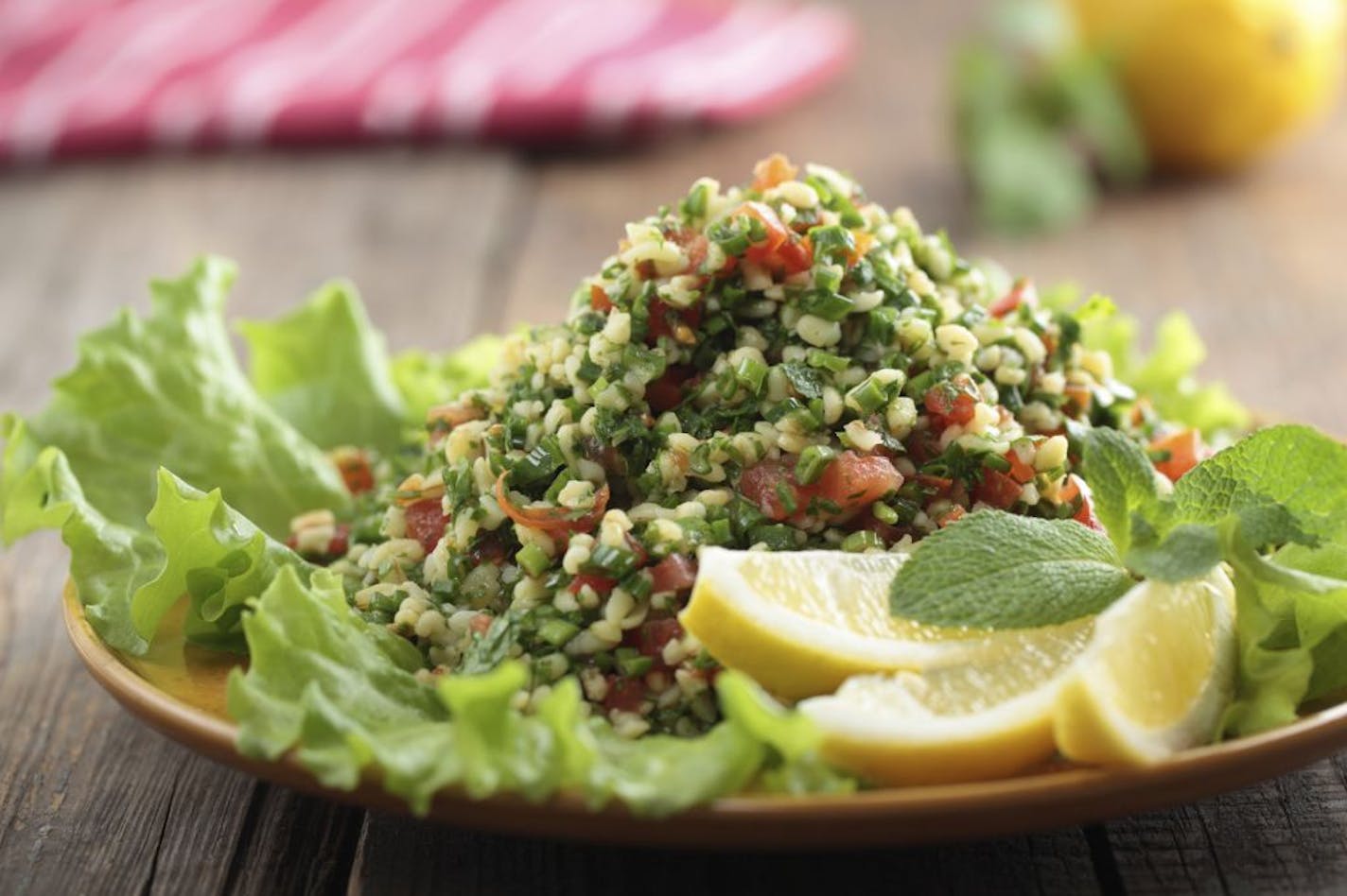 A traditional tabbouleh salad has a base of bulgur, tomatoes, cucumbers and onions.