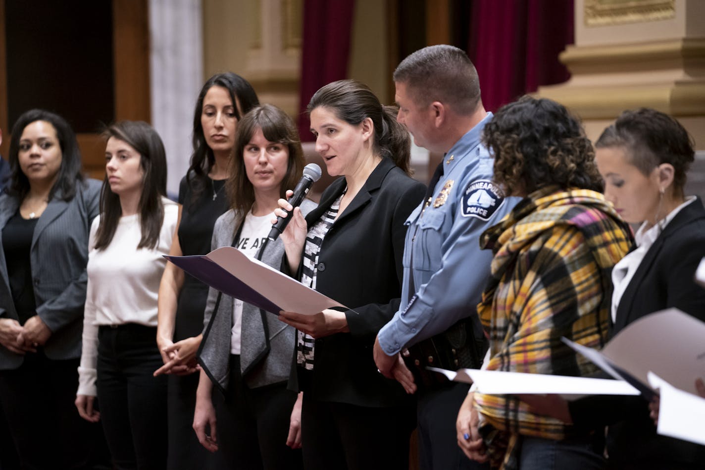 Council Member Linea Palmisano (with microphone) stood Wednesday at the front of the City Hall Chambers with justice officials, survivors and other council members to declare April Sexual Assault Awareness Month.