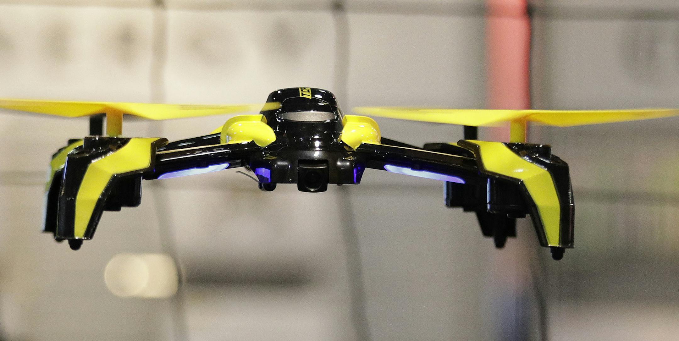 FILE - In this Jan. 5, 2017 file photo, a drone flies in Las Vegas. The world&#x2019;s largest manufacturer of civilian drones is proposing that drones be required to continually transmit identification information to help government security agencies and law enforcement figure out which might belong to rogue operators. (AP Photo/John Locher, File)