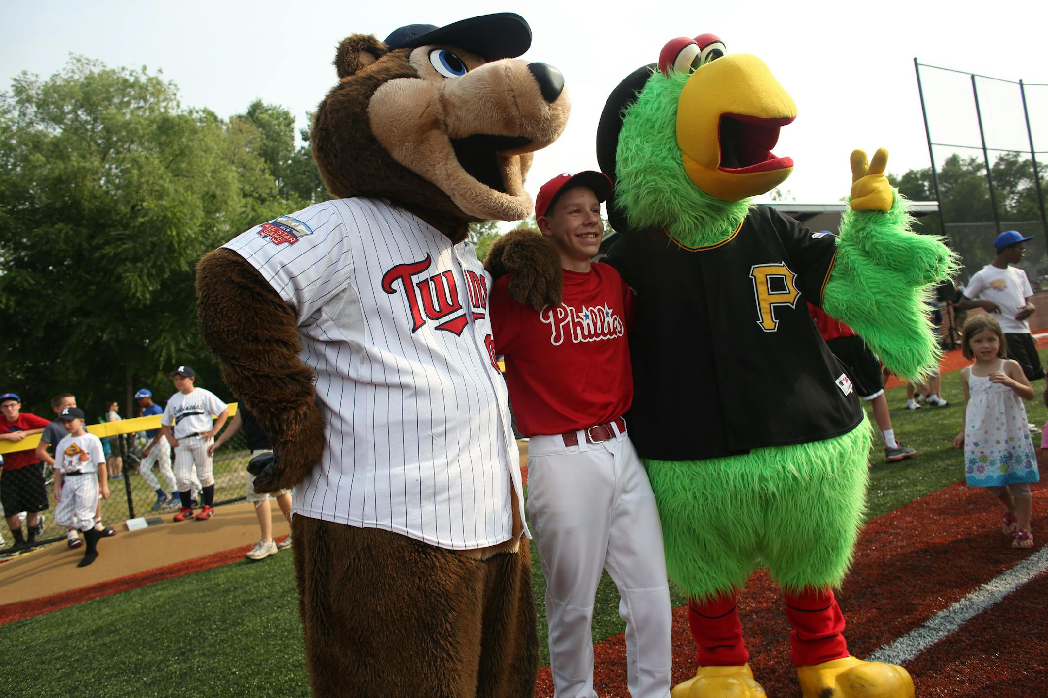 George Wolf, 14, posed with Pirates Parrot and TC Bear from the Twins after the dedication ceremony. ] (KYNDELL HARKNESS/STAR TRIBUNE) kyndell.harkness@startribune.com At Lee Field in St. Paul, Min. Thursday, July 9, 2014. A baseball field in Robbinsdale has gotten a big upgrade, with a large part of the funding coming from Major League Baseball in conjunction with the All Star game.