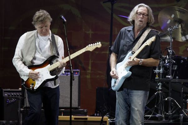 Steve Winwood, left, and Eric Clapton perform together during the Crossroads Guitar Festival.