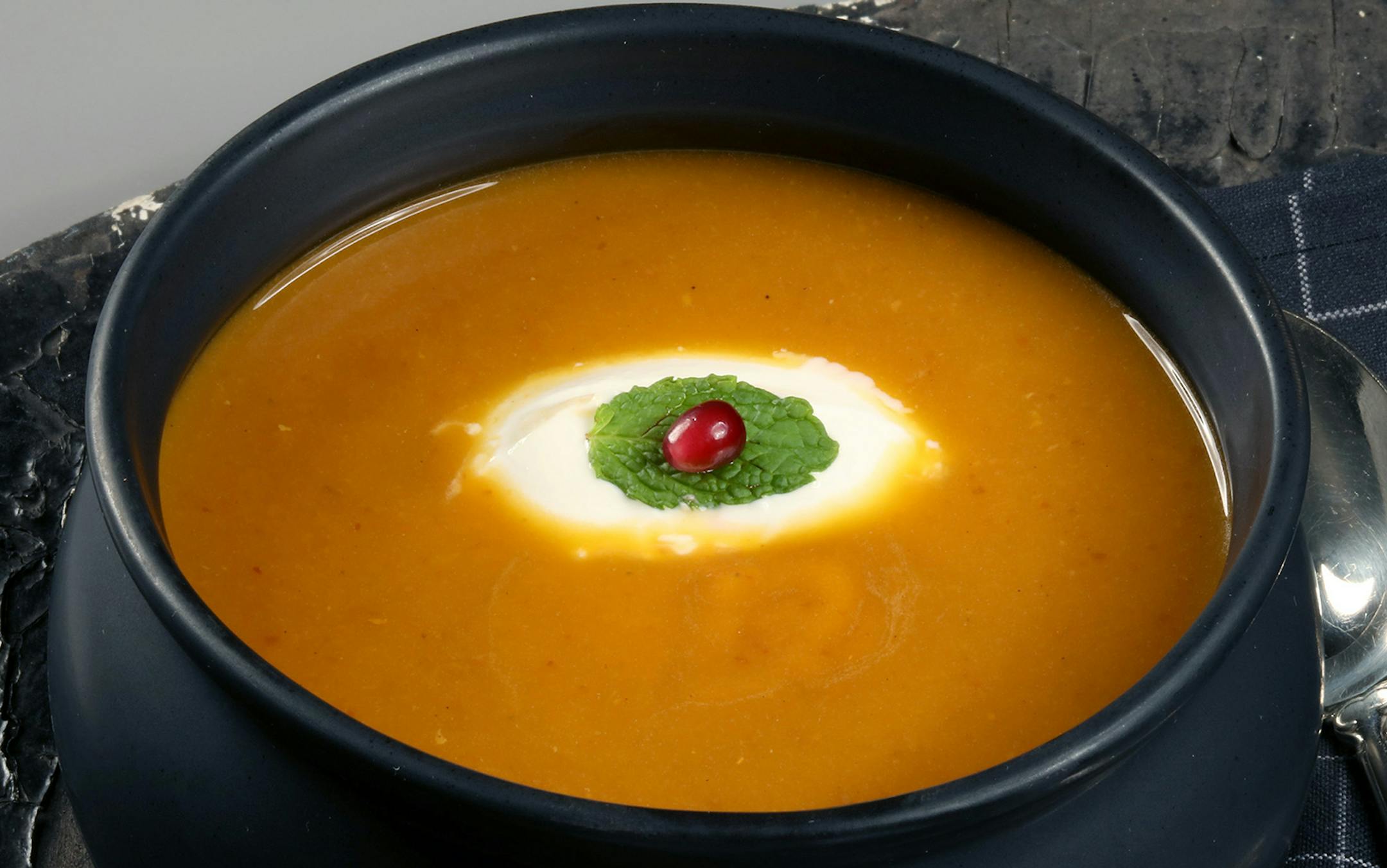 Yogurt, pomegranate seeds, finely chopped mint stirred together, or for a creepy eyeball look, dollop yogurt into the soup, float a small mint leaf in the middle and finish with a single pomegranate seed. (E. Jason Wambsgans/Chicago Tribune/TNS) ORG XMIT: 1175548