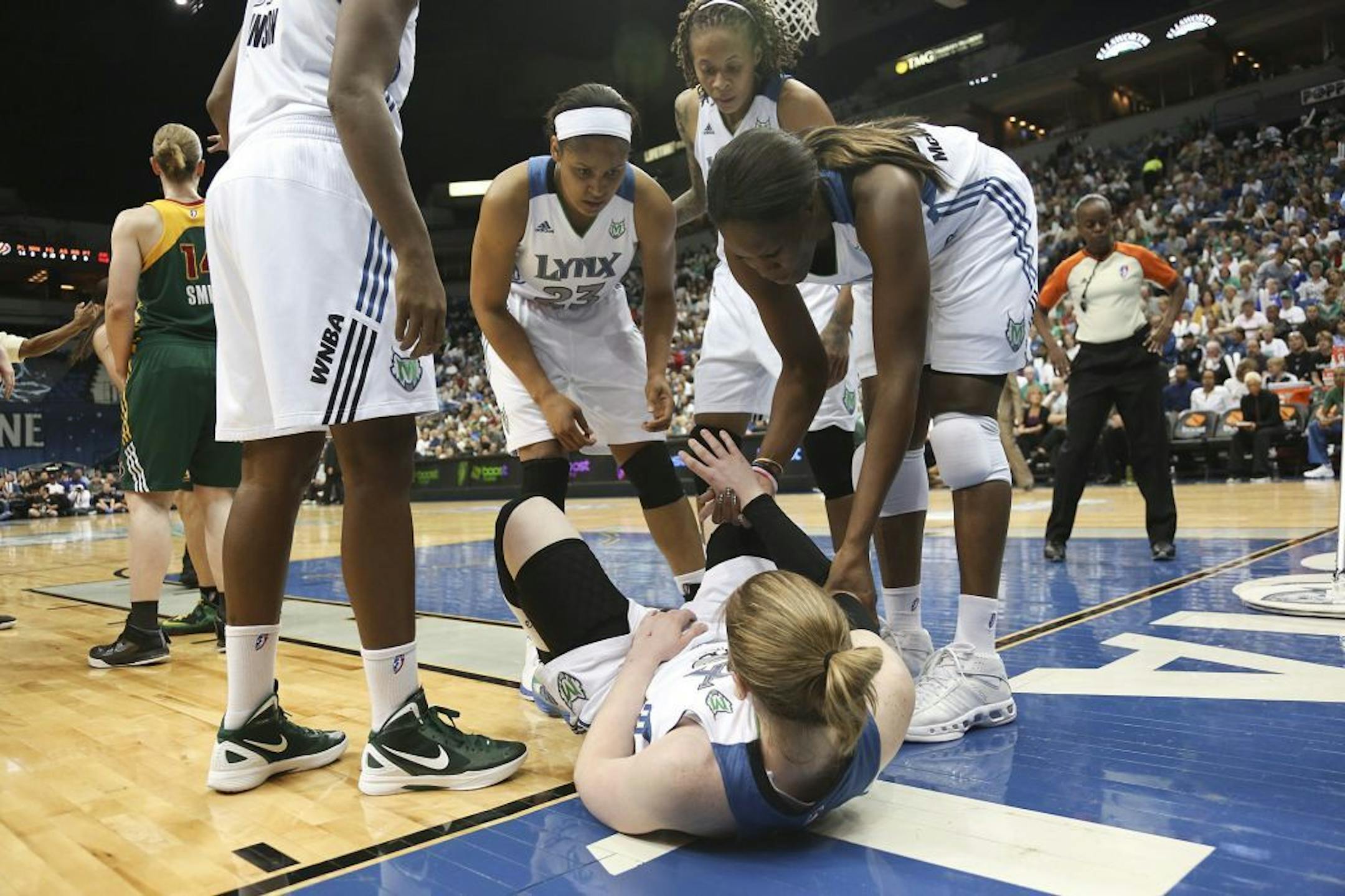 Taj McWilliams-Franklin helped up teammate Lindsay Whalen after she hit the deck going after a loose ball in the second quarter of Game 3 in the Western conference semifinals at the Target Center.