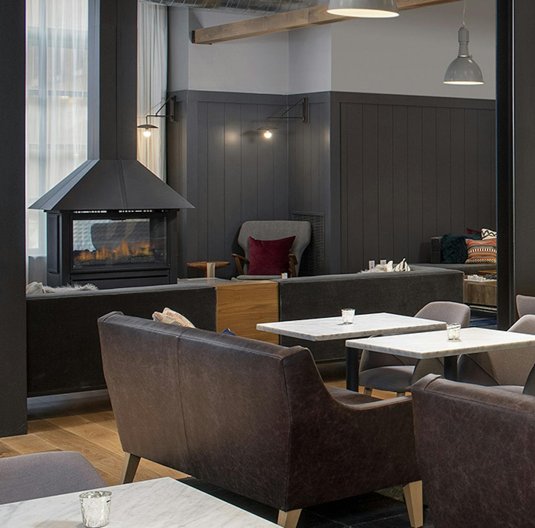 A fireplace anchors the lobby, restaurant and bar area at the new Canopy by Hilton Ithaca Downtown. Provided photo.