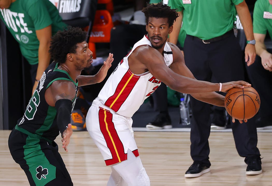 Heat star Jimmy Butler looked around Boston defender Marcus Smart during Game 2 of the NBA’s Eastern Conference finals last week.