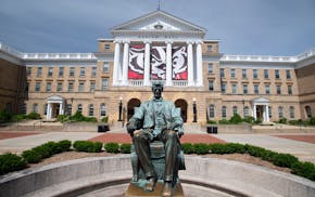 The Abraham Lincoln statue is pictured in front of Bascom Hall at the University of Wisconsin-Madison during spring on June 8, 2016. Hanging between t