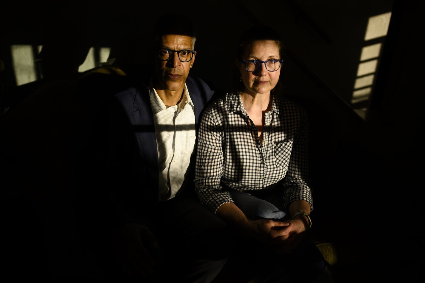 Chris Robinson and his wife Margaret Miller sat for a portrait in a slit of light coming in through their living room window being emitted by new Xcel streetlights outside their south Minneapolis home.