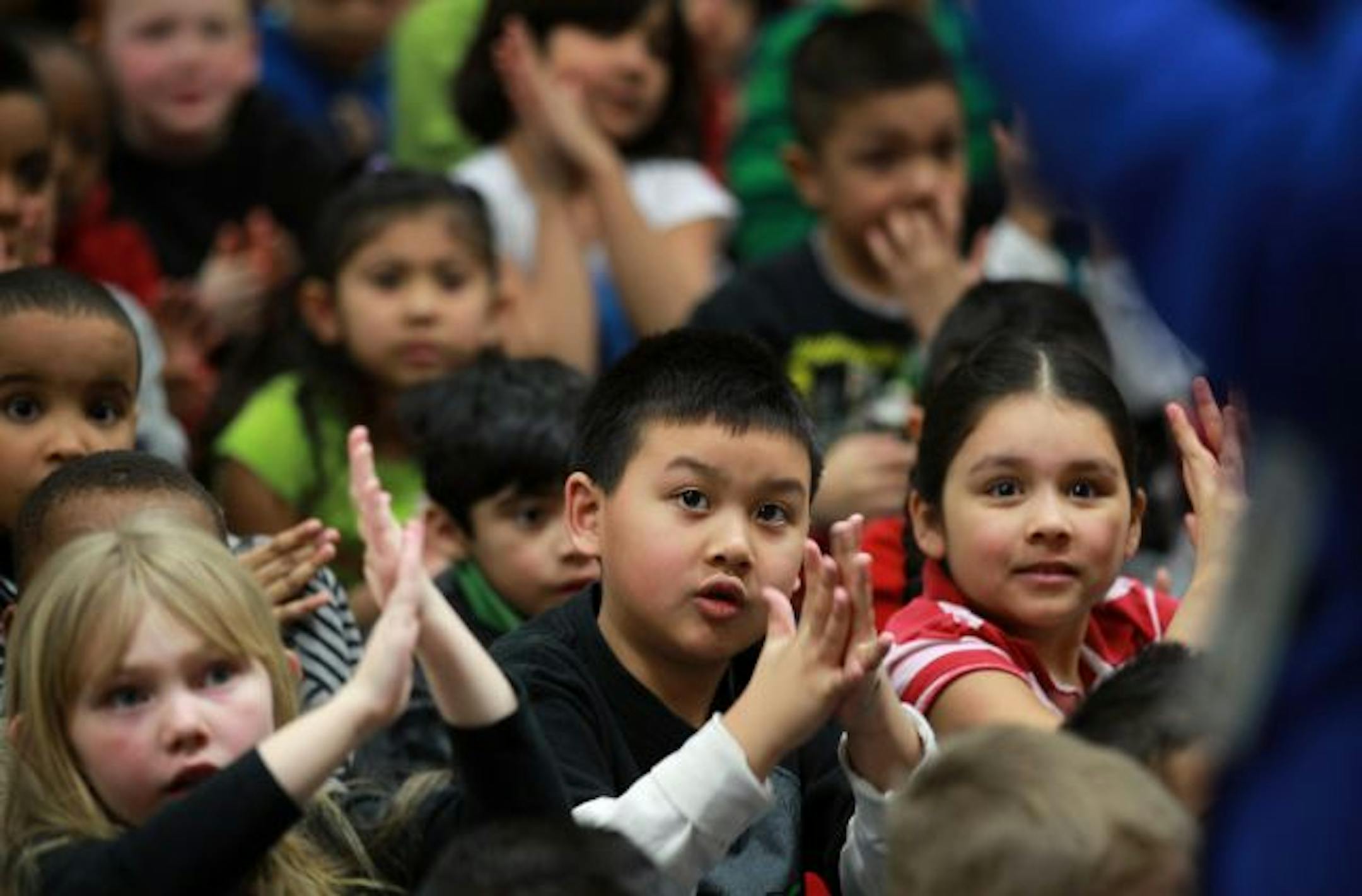 Kindergartners interacted during a presentation of dinosaur fossils at Centennial Elementary.
