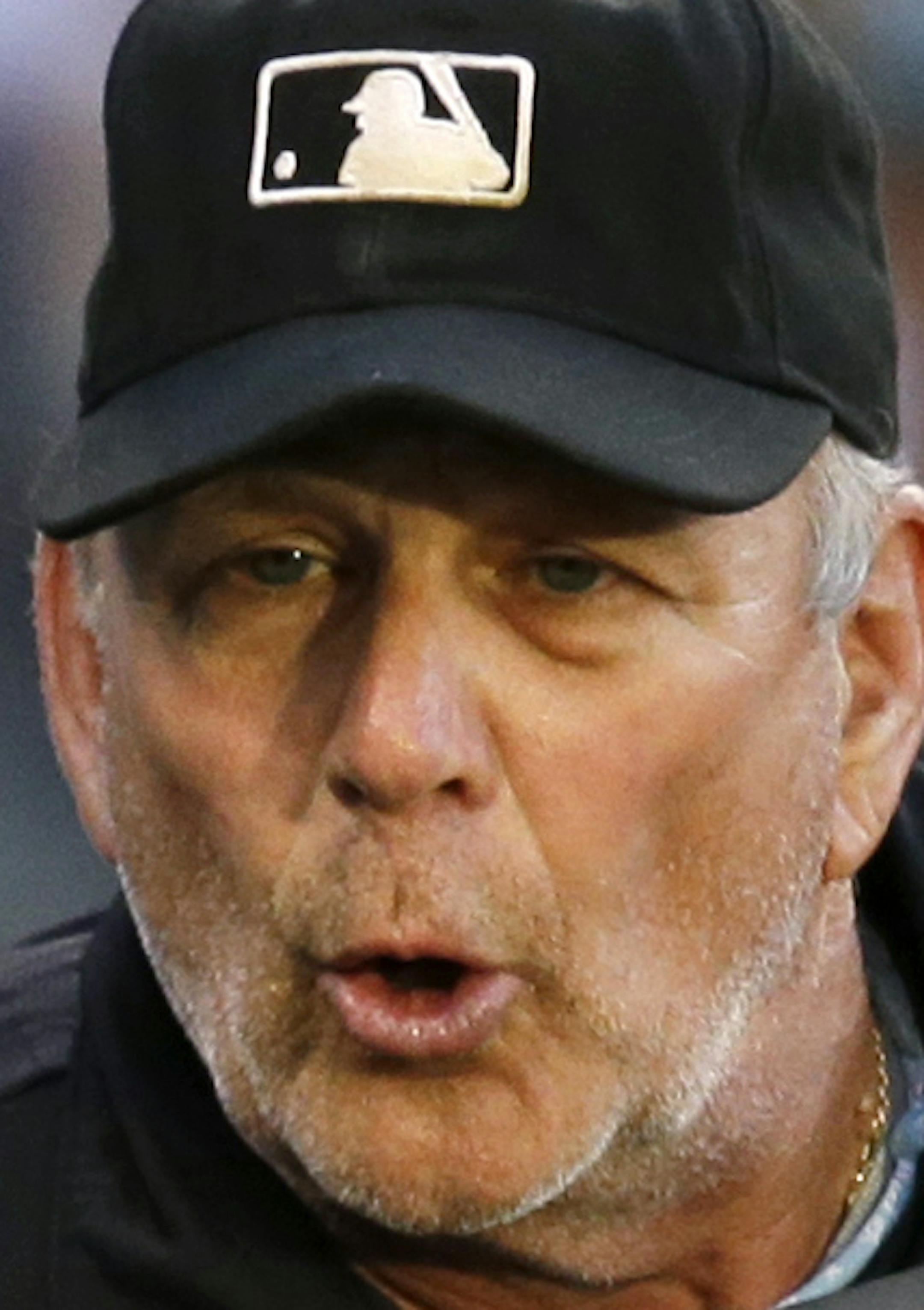 Seattle Mariners manager Lloyd McClendon, left, talks with plate umpire Bob Davidson after Davidson ejected Brad Miller in the fourth inning of a baseball game Saturday, July 12, 2014, in Seattle. (AP Photo/Elaine Thompson)