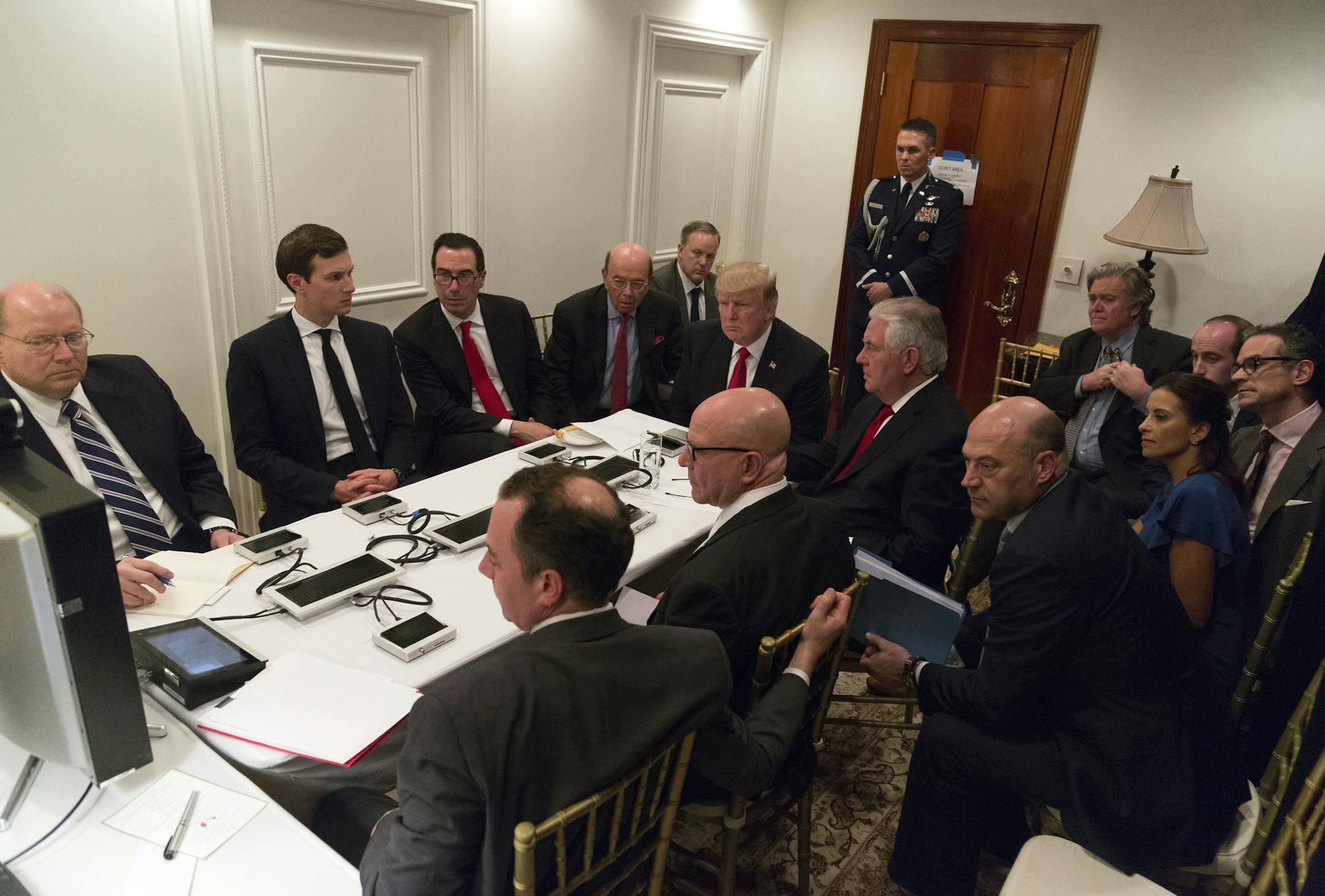 In a photo provided by the White House, Donald Trump and administration figures are briefed on the strike on an air base in Syria at his Mar-a-Lago estate in Palm Beach, Fla., April 6, 2017. Seated clockwise from left: Joseph Hagin, deputy chief of staff; Jared Kushner; Steven Mnuchin, the Treasury secretary; Wilbur Ross, the commerce secretary; Press Secretary Sean Spicer; Trump; Steve Bannon, his chief strategist; Stephen Miller, a senior adviser; Michael Anton, the National Security Council s