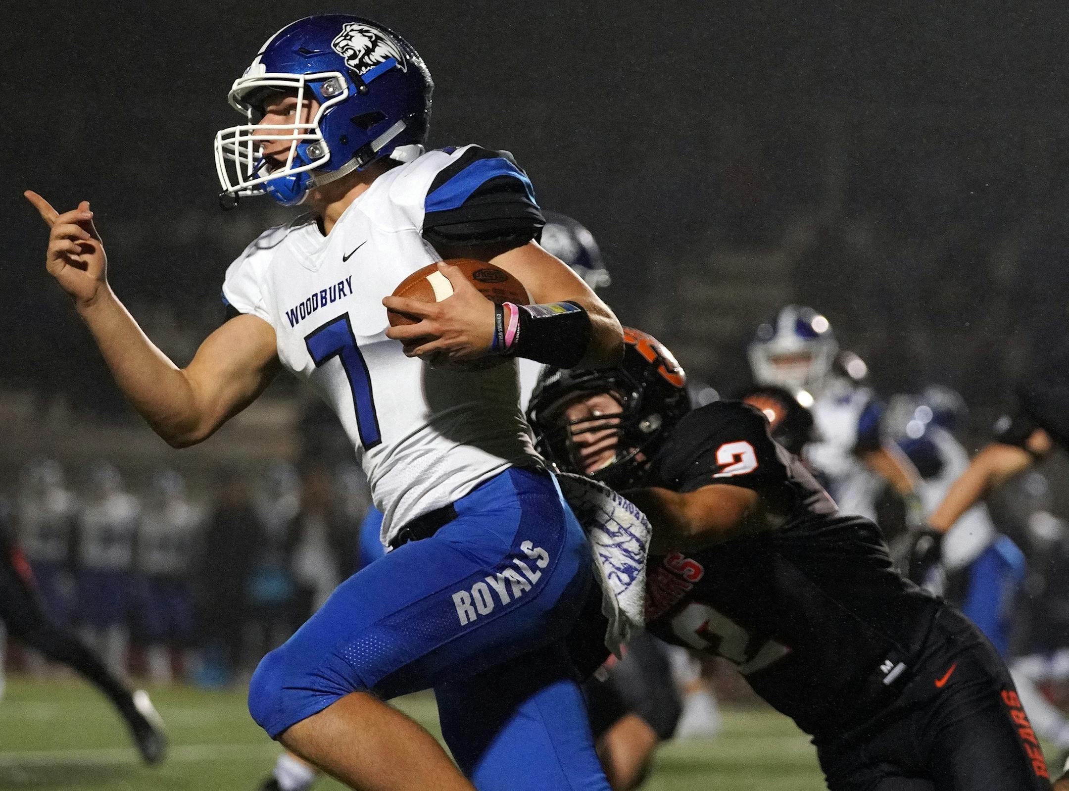Woodbury High School quarterback Jake Wenzel (7) sprinted with the ball after he was unable to find an open receiver as White Bear Lake Area High School running back Zachary Griebel (2) dove out to make the stop in the first half. ] ANTHONY SOUFFLE &#x2022; anthony.souffle@startribune.com White Bear Lake Area High School played Woodbury High School in an MSHSL football game Friday, Oct. 5, 2018 at White Bear Lake Area High School in White Bear Lake, Minn.