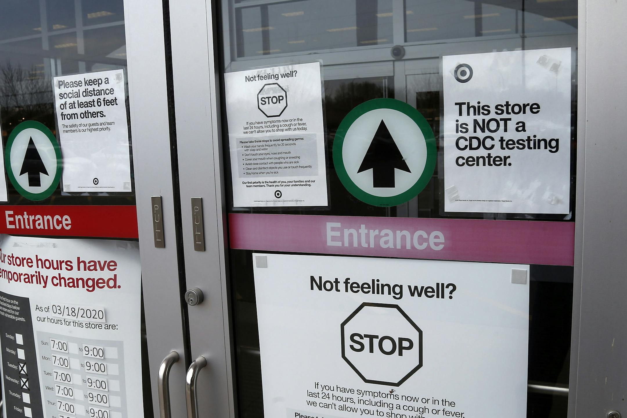 Shoppers to a Super Target store Thursday, April 23, 2020, in Minnetonka, Minn. are greeted with numerous signs related to the coronavirus issues. (AP Photo/Jim Mone)